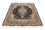 Persian Tabriz rug khatibi design with black medallion field and intricate floral border with silk and fine wool