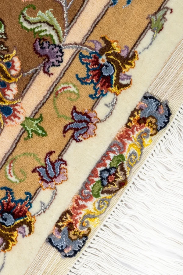 Hand-knotted Persian Khatibi rugs from Mashhad with intricate ivory and gold floral design, crafted in fine wool and silk.