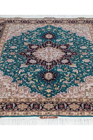 Hand-knotted Persian Heris design carpet from Tabriz, featuring teal green and black medallion pattern with silk-accented floral motifs – 2 x 1.5 meters.