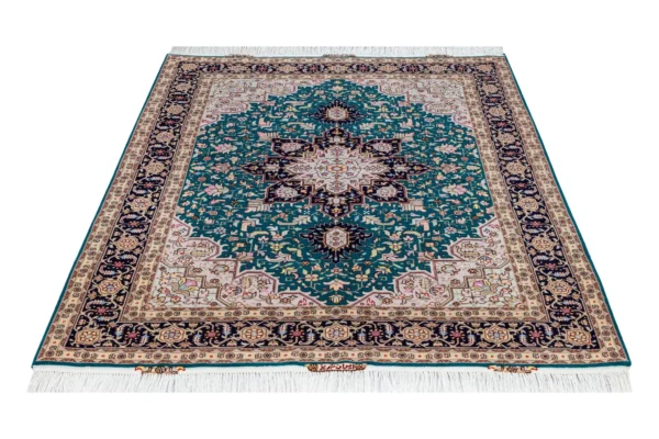 Hand-knotted Persian Heris design carpet from Tabriz, featuring teal green and black medallion pattern with silk-accented floral motifs – 2 x 1.5 meters.