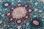 Hand-knotted Persian Heris design carpet from Tabriz, featuring teal green and black medallion pattern with silk-accented floral motifs – 2 x 1.5 meters.