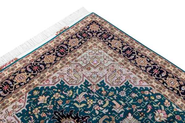 Hand-knotted Persian Heris design carpet from Tabriz, featuring teal green and black medallion pattern with silk-accented floral motifs – 2 x 1.5 meters.
