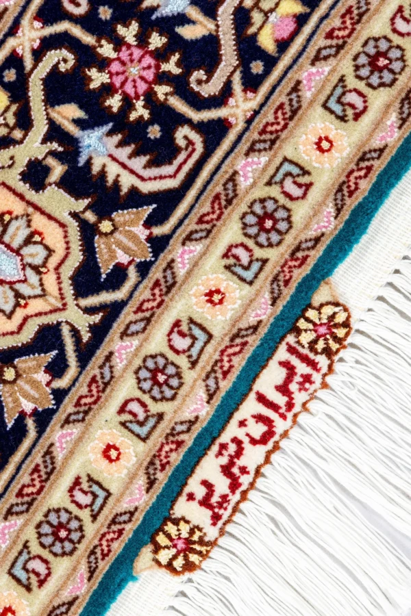 Hand-knotted Persian Heris design carpet from Tabriz, featuring teal green and black medallion pattern with silk-accented floral motifs – 2 x 1.5 meters.