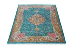 Qom silk carpet in full natural silk, hand-knotted in Iran with 80 Raj density. Features a turquoise floral design with central medallion.