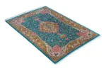 Qom silk carpet in full natural silk, hand-knotted in Iran with 80 Raj density. Features a turquoise floral design with central medallion.
