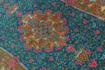 Qom silk carpet in full natural silk, hand-knotted in Iran with 80 Raj density. Features a turquoise floral design with central medallion.