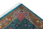 Qom silk carpet in full natural silk, hand-knotted in Iran with 80 Raj density. Features a turquoise floral design with central medallion.
