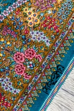 Qom silk carpet in full natural silk, hand-knotted in Iran with 80 Raj density. Features a turquoise floral design with central medallion.