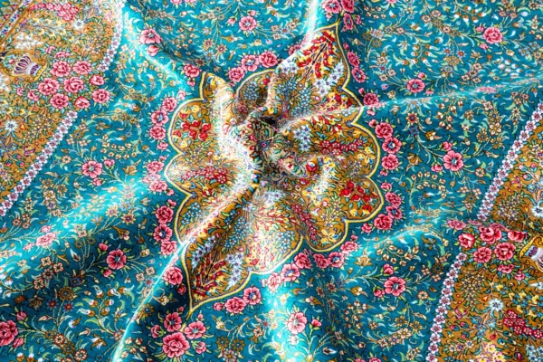 Qom silk carpet in full natural silk, hand-knotted in Iran with 80 Raj density. Features a turquoise floral design with central medallion.